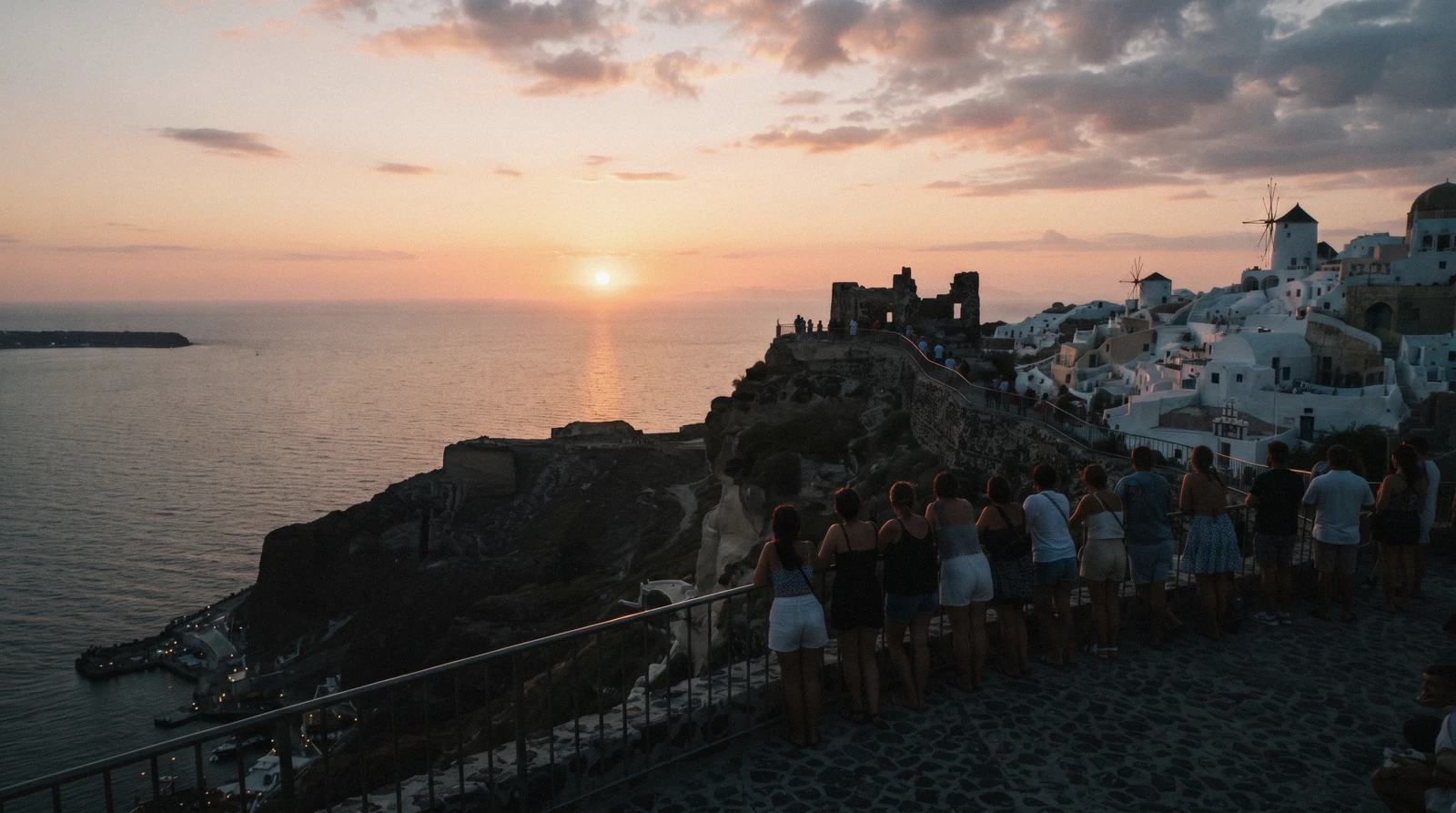 The western tip of Oia at the moment the sun touches the sea, santorini sunset, Santorini Greece