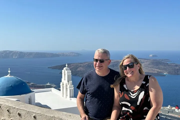 Blue-domed church above the caldera in Firostefani on a Santorini iconic villages tour, Santorini Greece