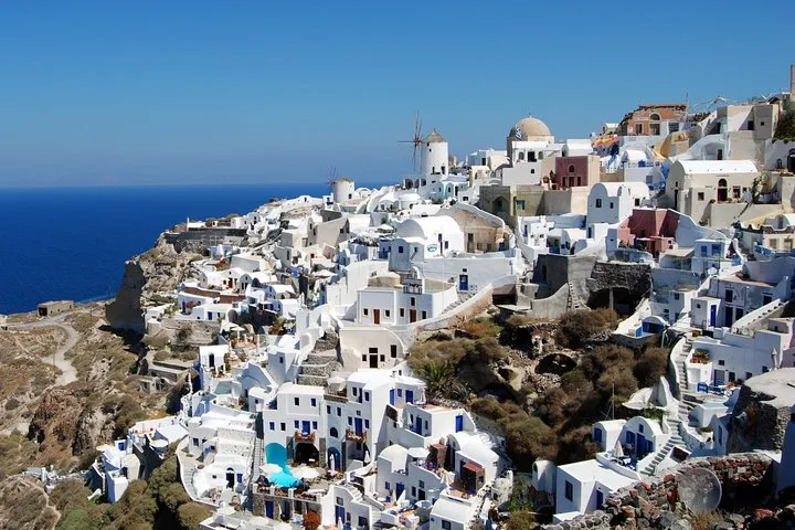 Crowds of rooftops in Oia at dusk on a full-day Santorini tour with the Oia sunset, Santorini Greece