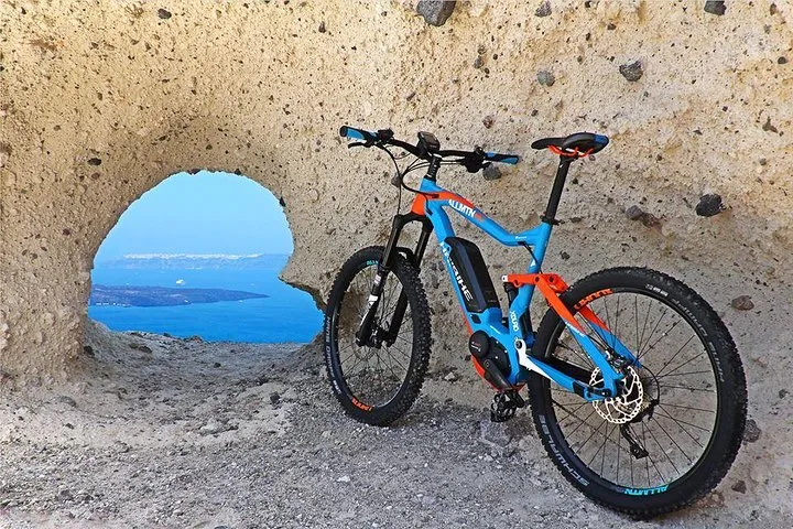 Electric mountain bikes on a village lane on a Santorini e-bike tour, Santorini Greece